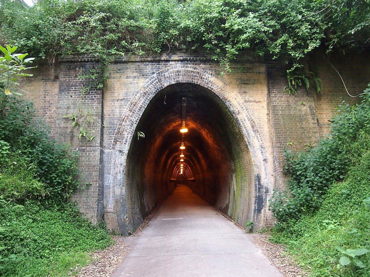The lit brick Fernleigh Tunnel on the Fernleigh Track shared pathway, New South Wales